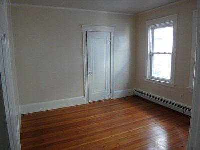 Bedroom with closet, window and hardwood floor at Acapulco