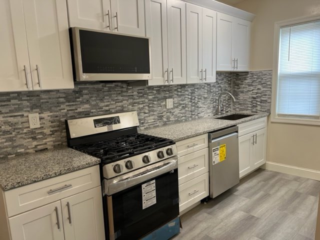 Luxury kitchen with granite counters and stainless steel appliances.