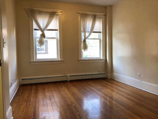 Bedroom with hardwood floors and natural light at Aruba