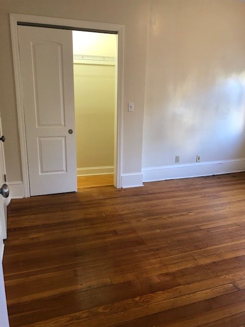Bedroom with hardwood floors and natural light at Aruba