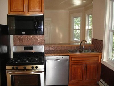 Kitchen with gas range, microwave, dishwasher and double sink at Aruba