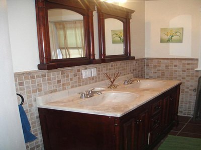 Double vanity with wood cabinets and twin mirrors at Bahamas