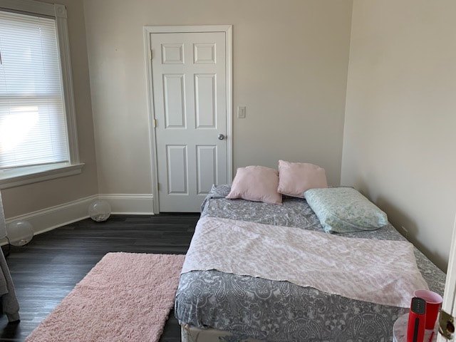 Bedroom with hardwood floors and natural light at Bahamas