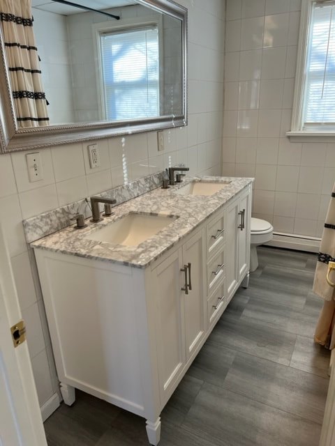 Renovated bathroom with tile and a granite vanity at Costa Rica