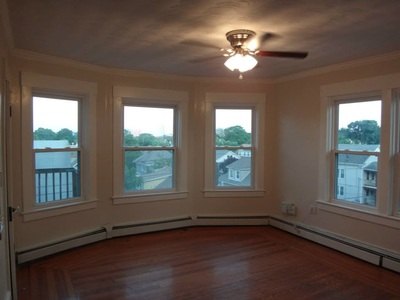 Corner living room with many windows and hardwood floor at Costa Rica