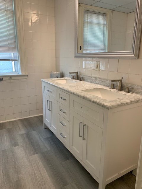 Renovated bathroom with tile and a granite vanity at Daytona Beach