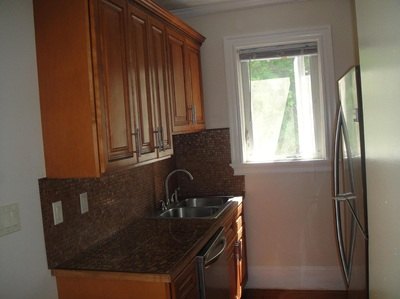 Kitchen with wood cabinets and dark granite counter at Daytona Beach