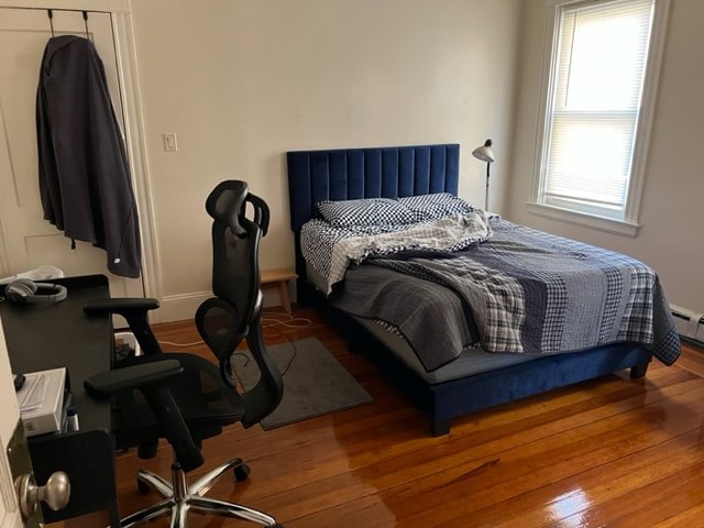 Bedroom with hardwood floors and natural light at Jamaica