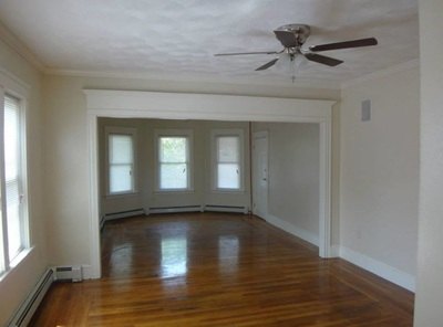 Living room with hardwood floors and a bay-window alcove at Jamaica