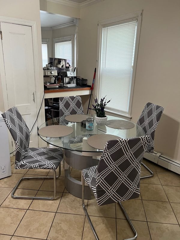 Round glass dining table with four chairs at South Beach